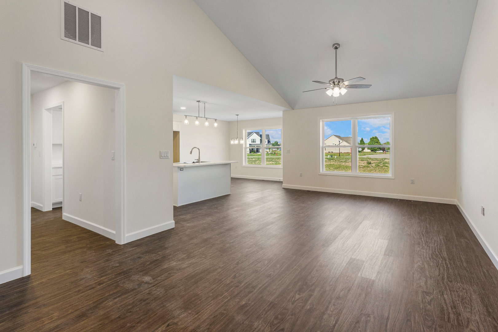 504 Patterson Drive Bloomington, IL 61701 - Photo 5 of 26 an empty room with wooden floor chandelier and windows