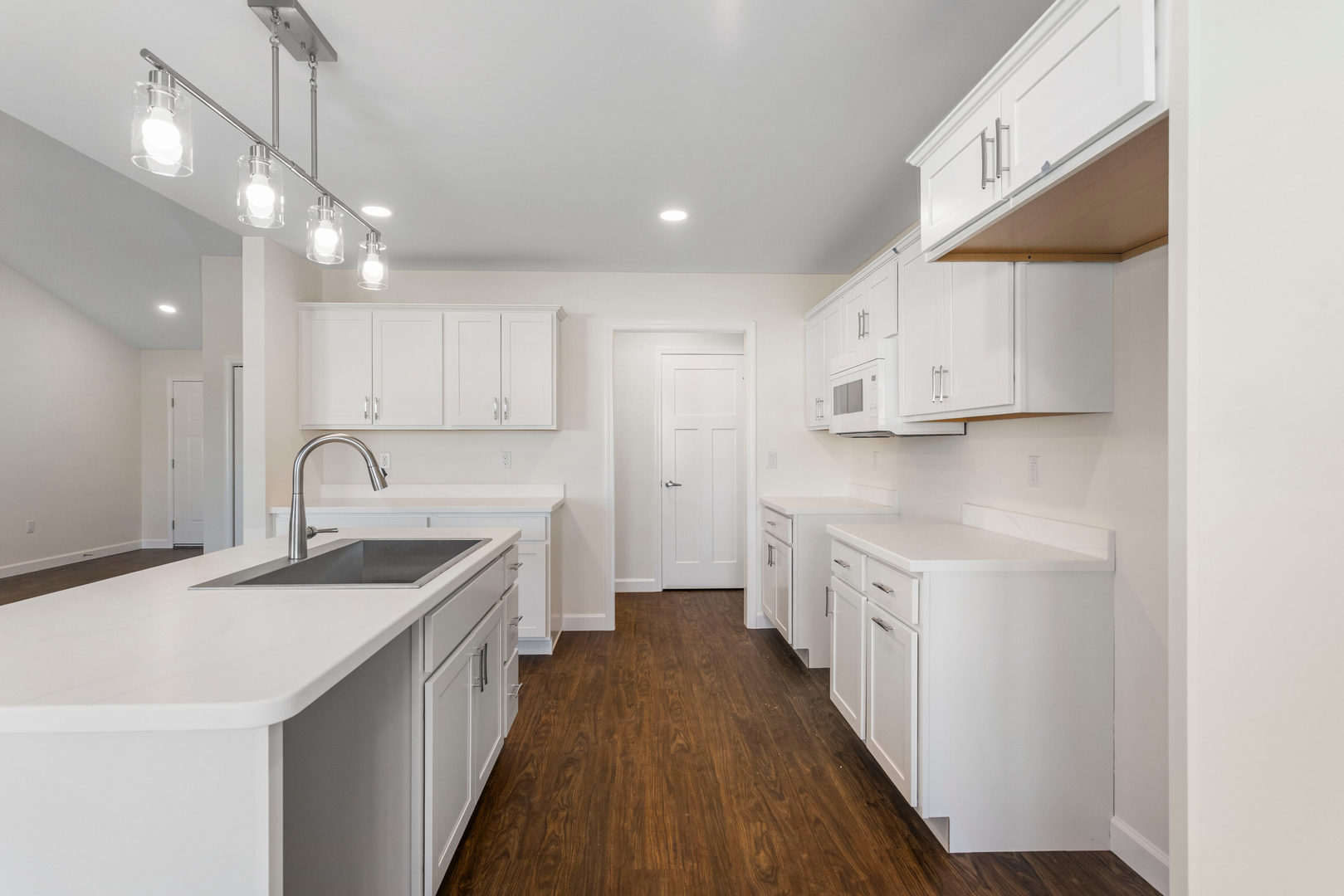 504 Patterson Drive Bloomington, IL 61701 - Photo 8 of 26 a kitchen with white cabinets sink and stove