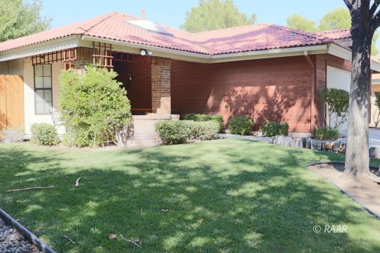 240 West Sequoia Place Ridgecrest, CA 93555 - Photo 3 of 32 a front view of a house with garden