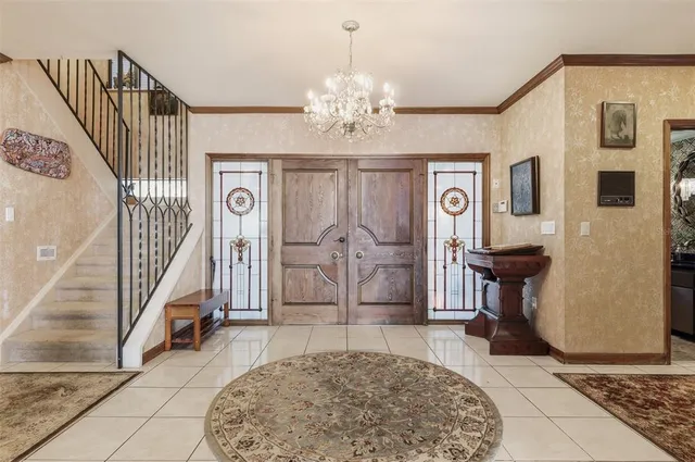 a view of a dining room with furniture and chandelier