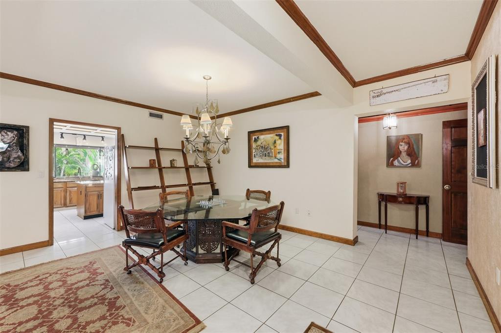 1066 Conover Street Port Charlotte, FL 33952 - Photo 18 of 80 a view of a dining room with furniture and chandelier
