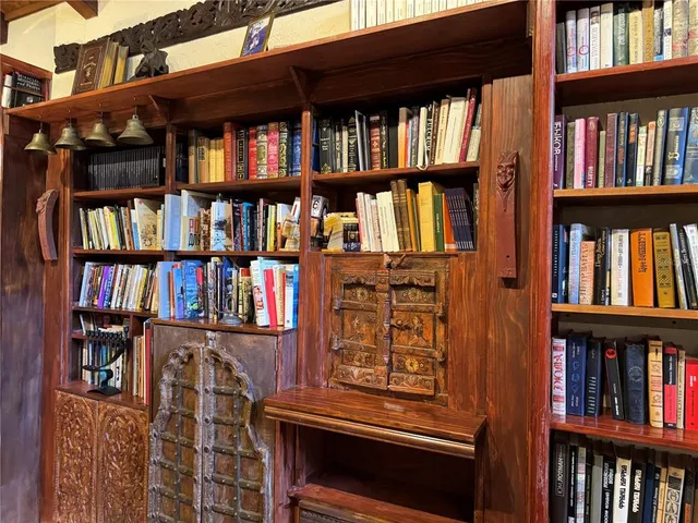a bathroom with a granite countertop tub a mirror and a shower