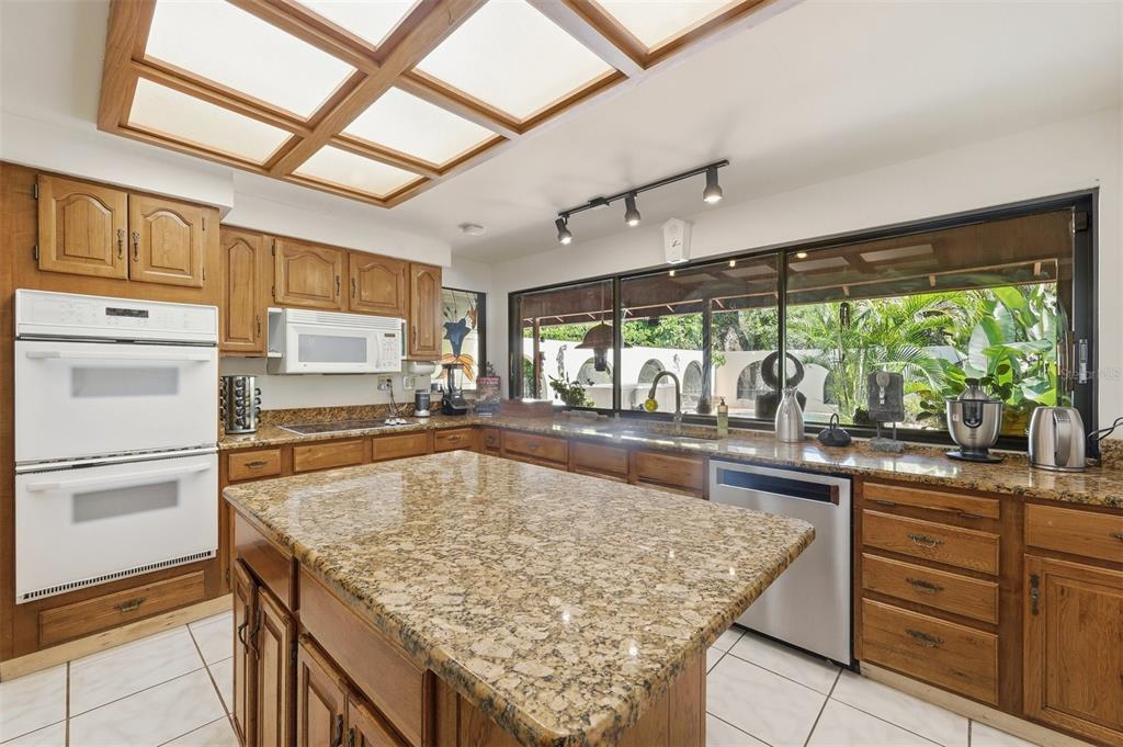 1066 Conover Street Port Charlotte, FL 33952 - Photo 24 of 80 a kitchen with stainless steel appliances granite countertop sink stove and refrigerator