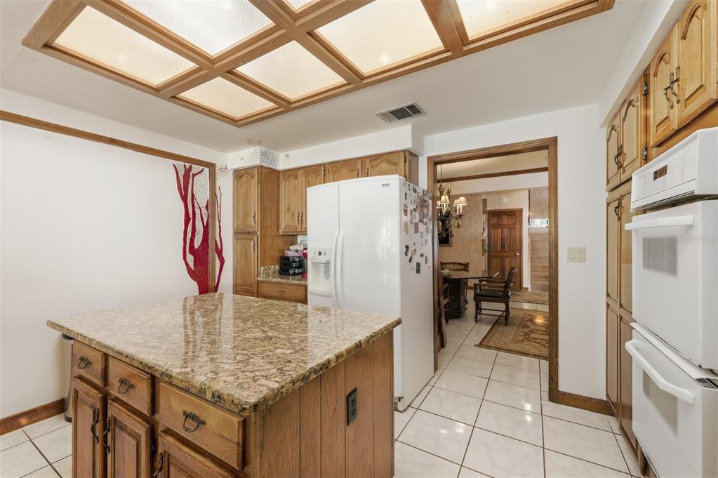 1066 Conover Street Port Charlotte, FL 33952 - Photo 25 of 80 a kitchen with stainless steel appliances granite countertop a sink refrigerator and cabinets