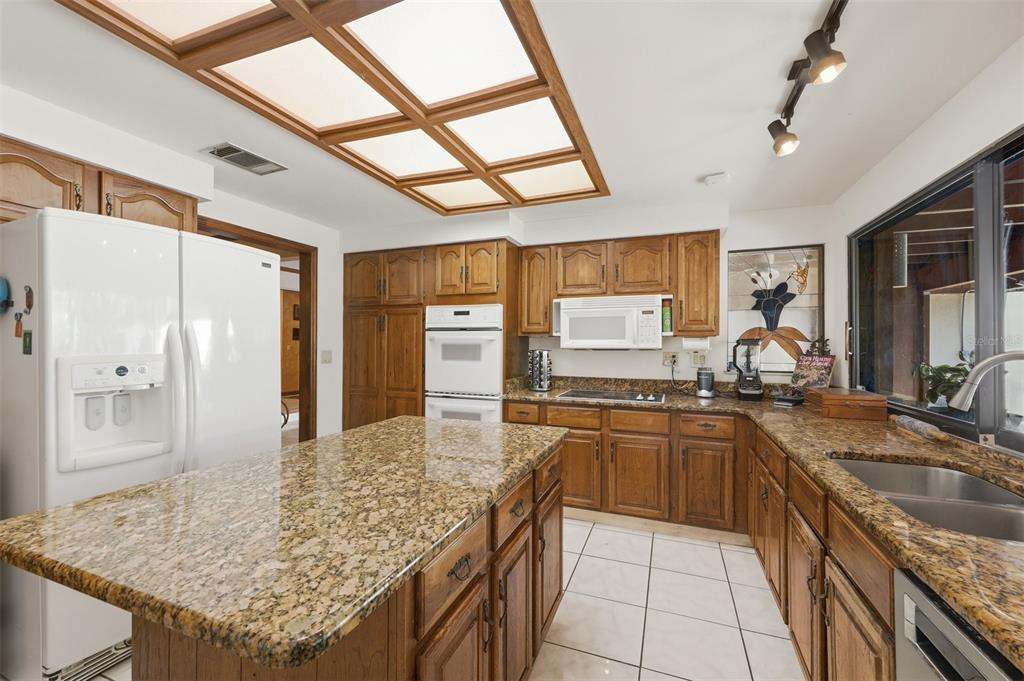 1066 Conover Street Port Charlotte, FL 33952 - Photo 26 of 80 a kitchen with stainless steel appliances granite countertop sink stove and refrigerator