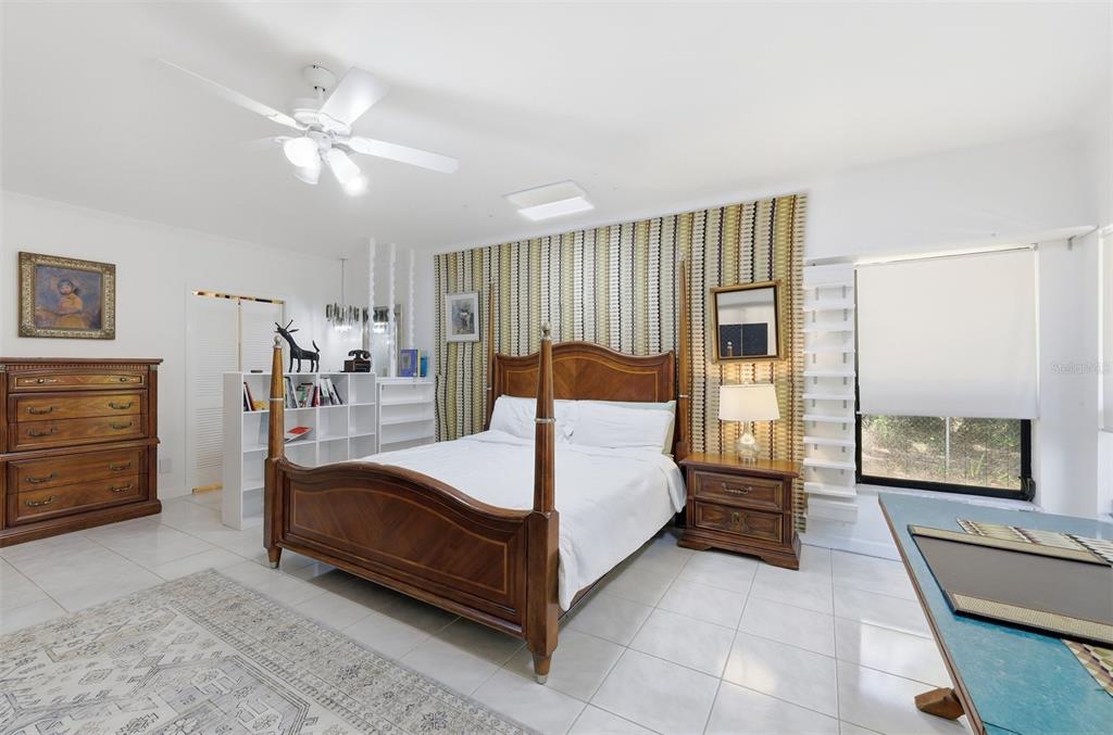 1066 Conover Street Port Charlotte, FL 33952 - Photo 31 of 80 a bedroom with a large bed and a chandelier