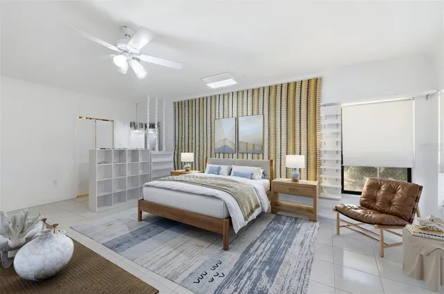 a living room with furniture a flat screen tv and a large window