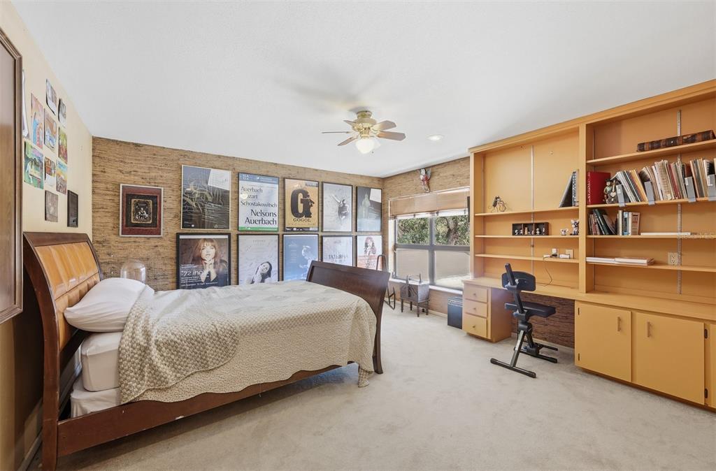 1066 Conover Street Port Charlotte, FL 33952 - Photo 43 of 80 a bedroom with a large bed and a chandelier