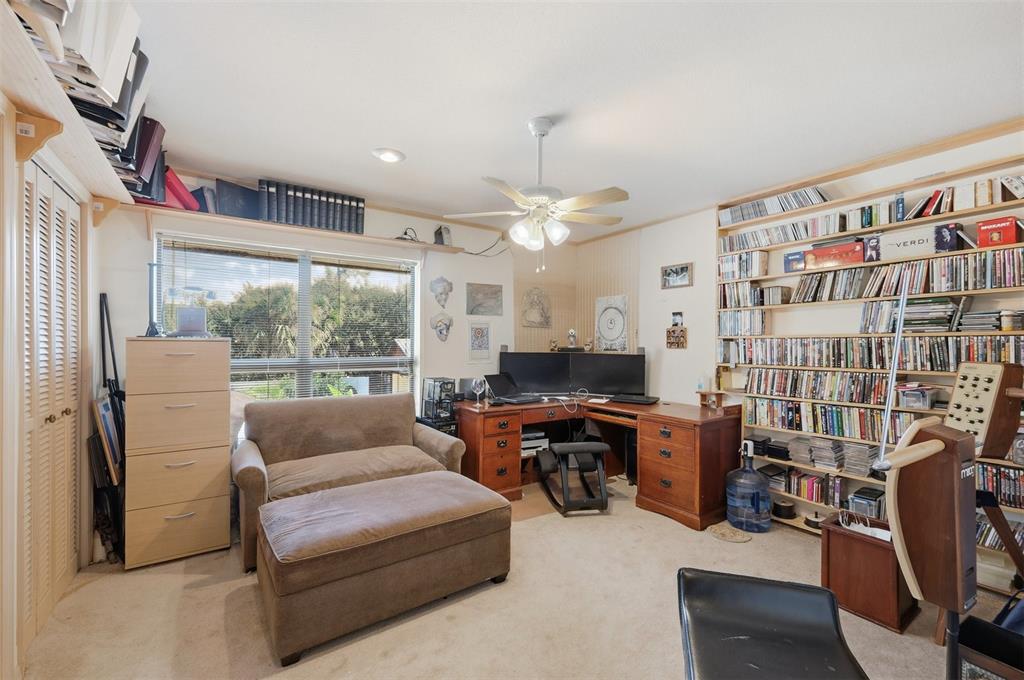 1066 Conover Street Port Charlotte, FL 33952 - Photo 48 of 80 a living room with furniture a flat screen tv and a large window