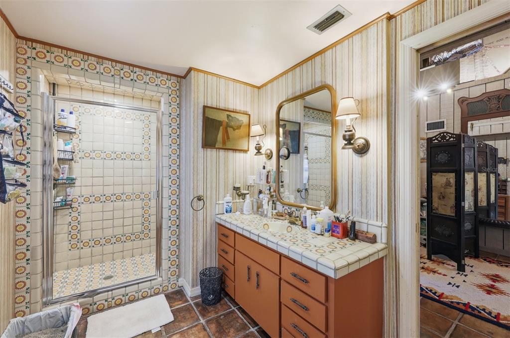 1066 Conover Street Port Charlotte, FL 33952 - Photo 69 of 80 a bathroom with a sink and a mirror