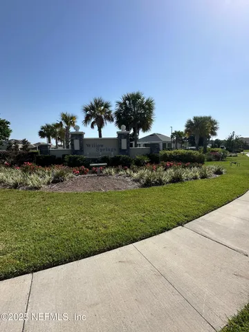 an empty room with wooden floor and glass door