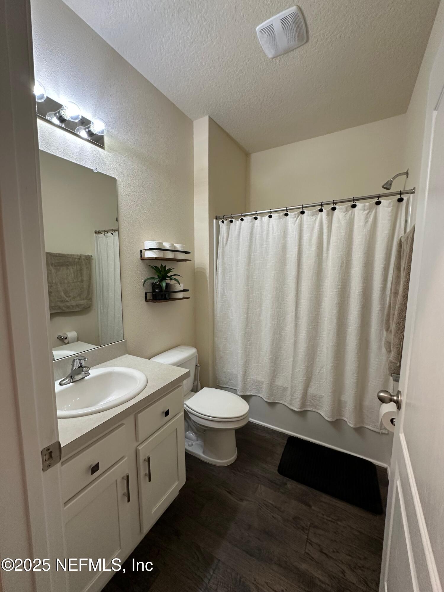 2062 Garrison Way Green Cove Springs Green Cove Springs, FL 32043 - Photo 22 of 56 a bathroom with a double vanity sink toilet and mirror