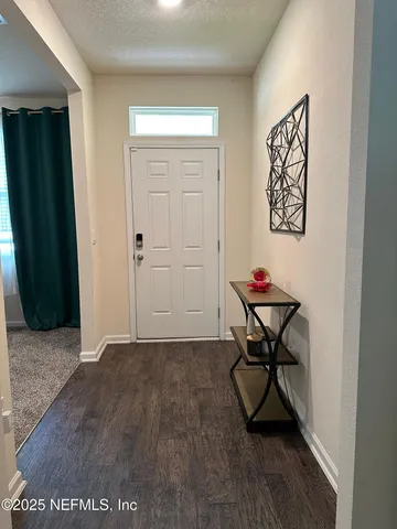 a kitchen with stainless steel appliances granite countertop a table chairs sink refrigerator and cabinets