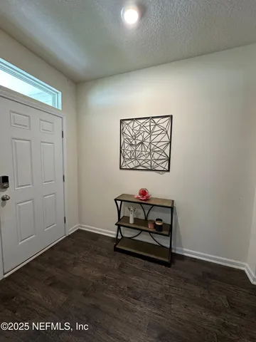 a view of a dining room with furniture and window