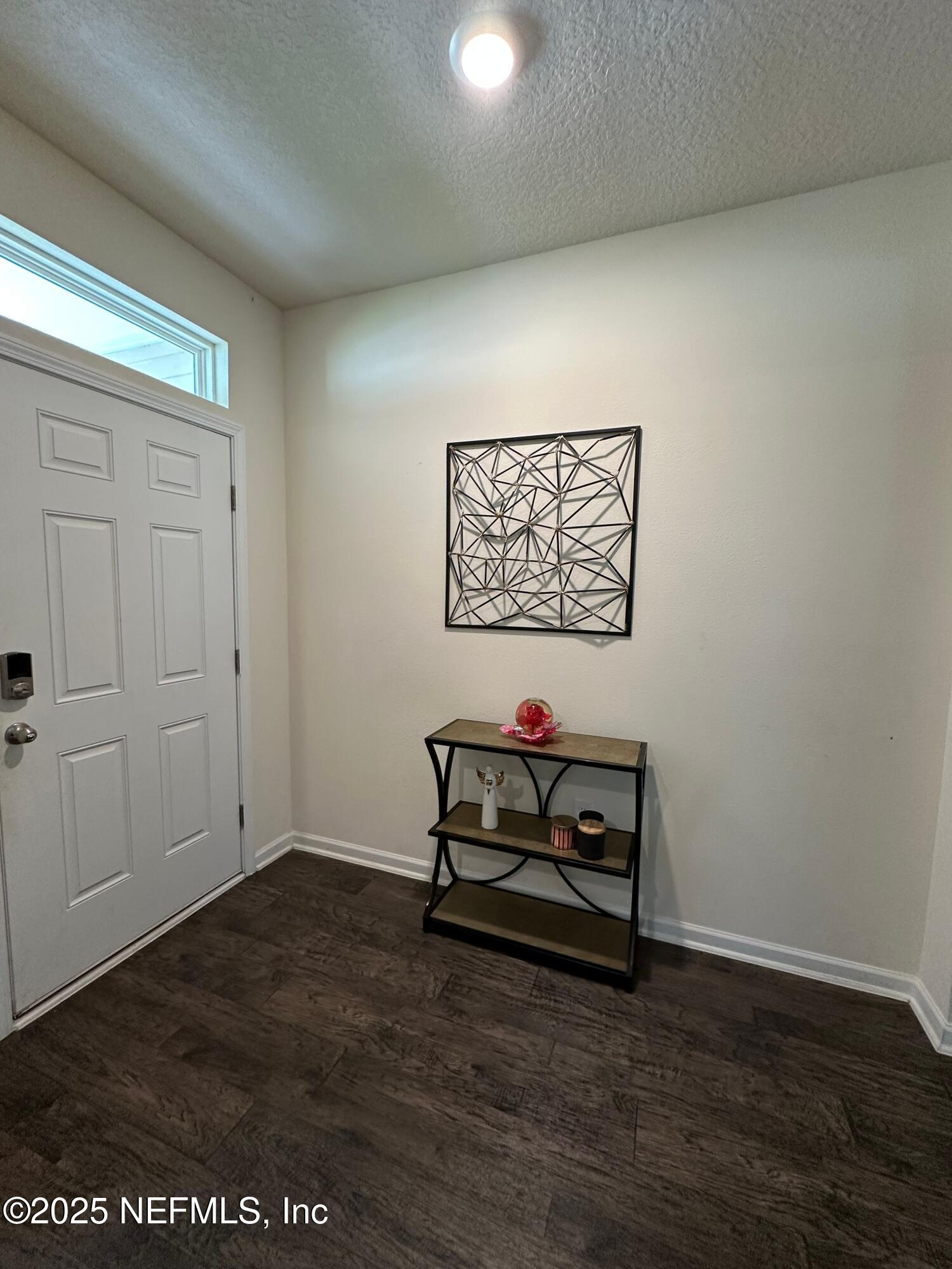 2062 Garrison Way Green Cove Springs Green Cove Springs, FL 32043 - Photo 4 of 56 an empty room with wooden floor and glass door