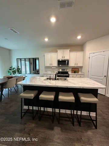 a living room with furniture a window and a flat screen tv