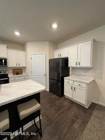 a bathroom with a double vanity sink toilet and mirror
