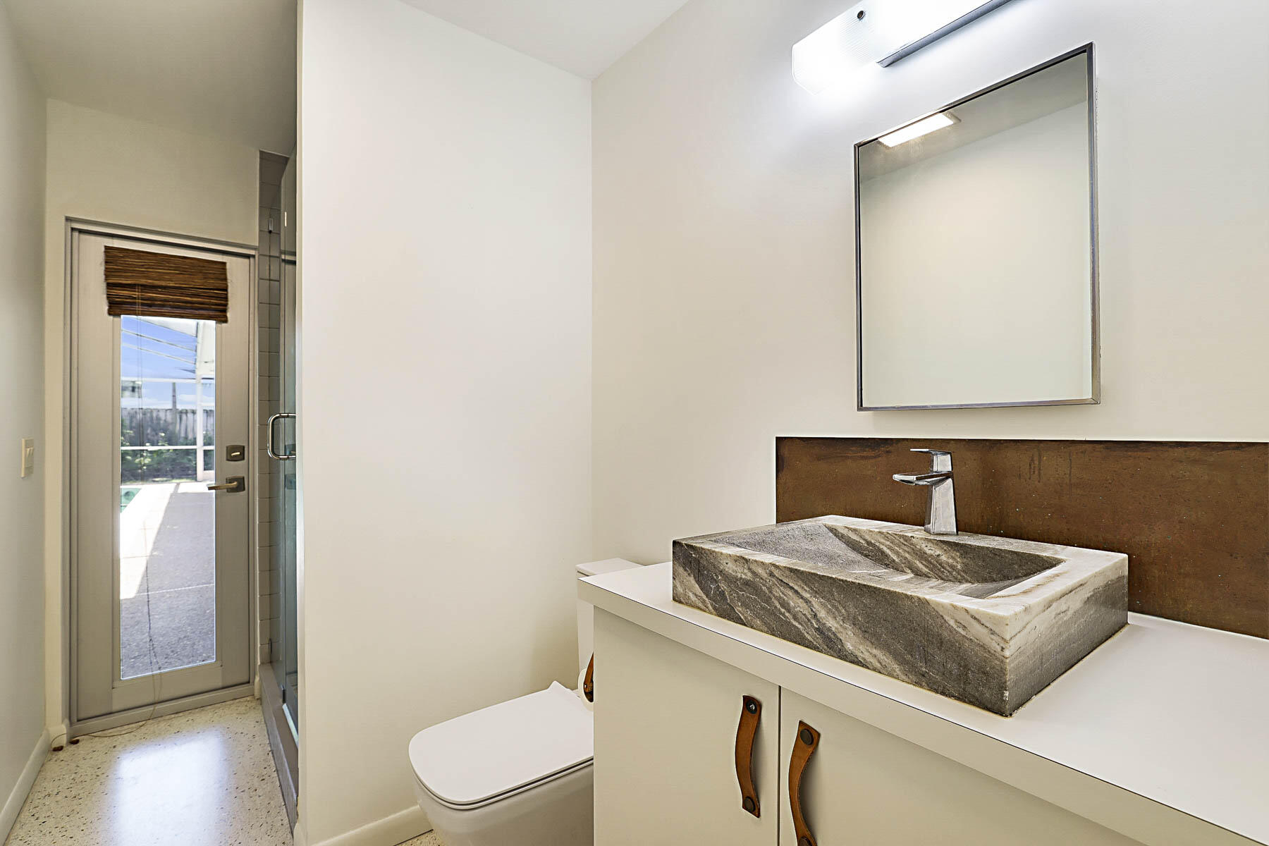 400 Northwest 6th Avenue Boca Raton, FL 33432 - Photo 25 of 44 a bathroom with a sink a toilet and mirror