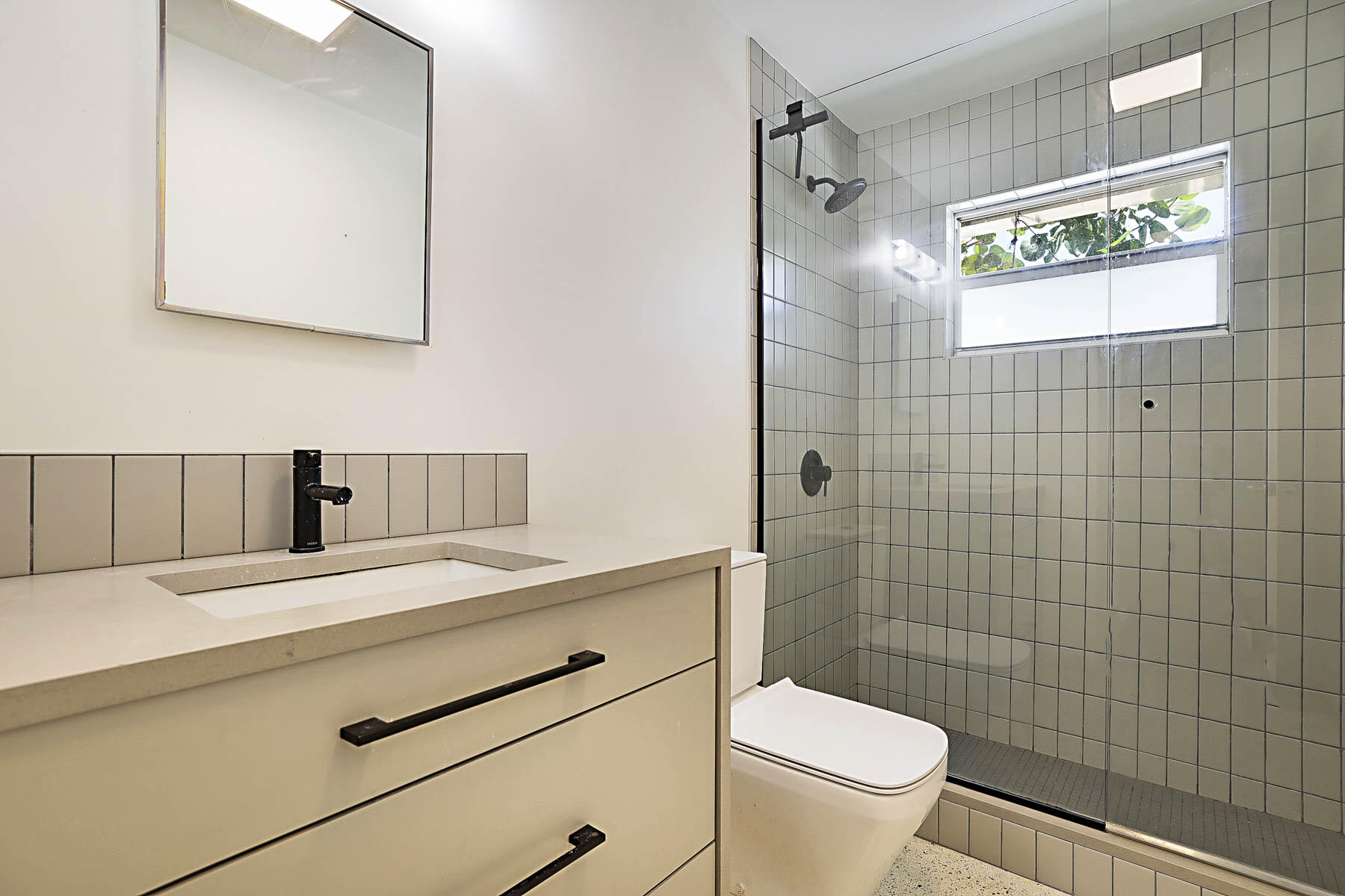 400 Northwest 6th Avenue Boca Raton, FL 33432 - Photo 29 of 44 a bathroom with a granite countertop sink a toilet and a mirror