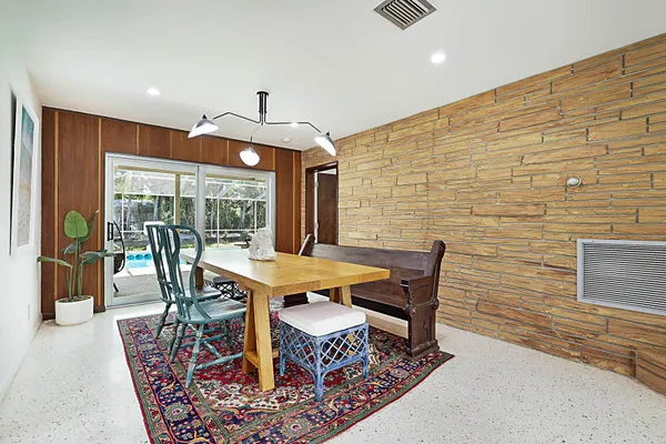 a dining room with furniture wooden floor and a rug