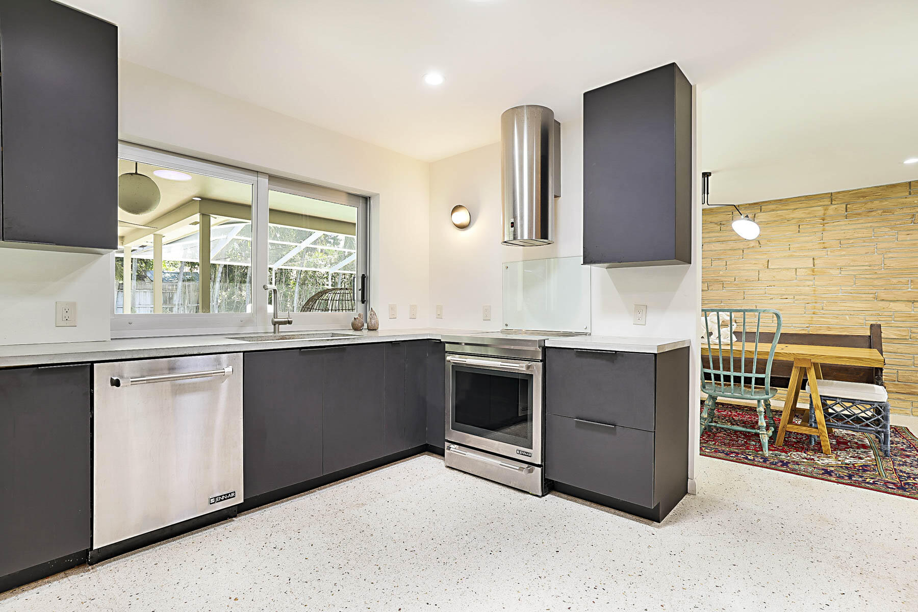 400 Northwest 6th Avenue Boca Raton, FL 33432 - Photo 9 of 44 a kitchen with stainless steel appliances granite countertop a stove a sink and a microwave