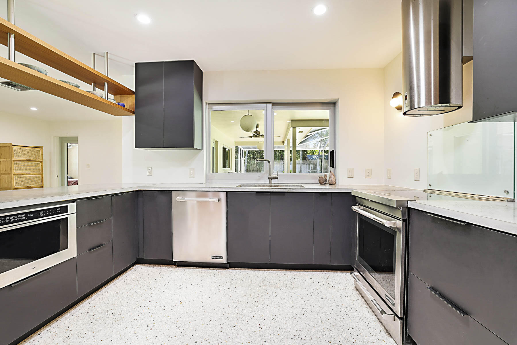 400 Northwest 6th Avenue Boca Raton, FL 33432 - Photo 10 of 44 a kitchen with stainless steel appliances granite countertop a stove a sink and a microwave