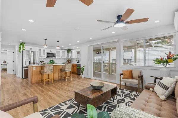 a living room with furniture and kitchen view