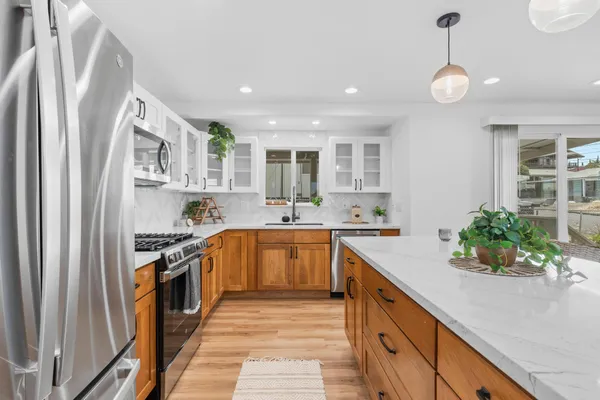 a kitchen with stainless steel appliances granite countertop a sink and stove