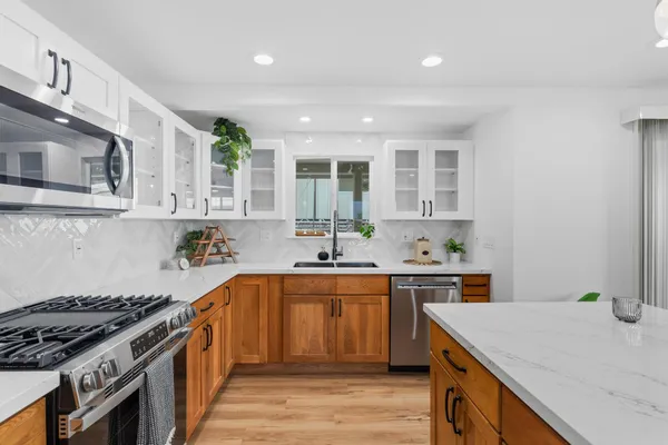 a kitchen with a sink stove and cabinets