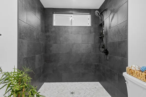a bathroom with a shower and a sink