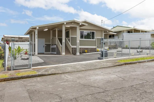 a view of a house with backyard and swimming pool