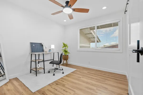 a workspace with wooden floor and a window