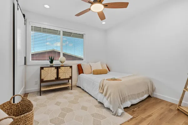 a bedroom with a bed and a chandelier