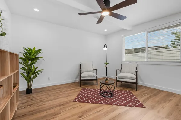 a living room with furniture and a potted plant