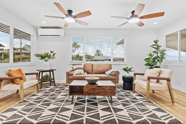 a living room with furniture a rug and a chandelier