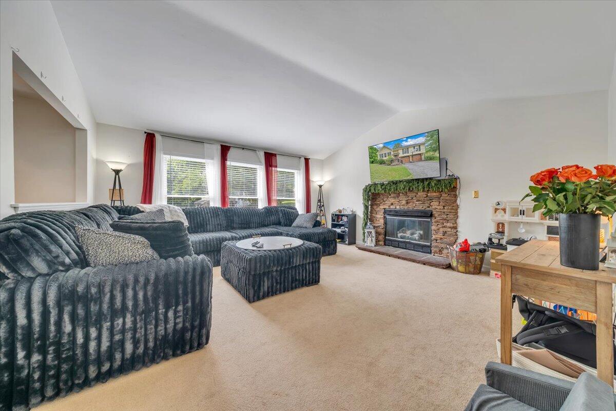 7851 Cedar Edge Road Roanoke, VA 24018 - Photo 4 of 44 a living room with furniture a fireplace and a flat screen tv