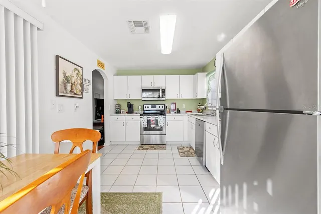 a bedroom with two beds and a bookshelf