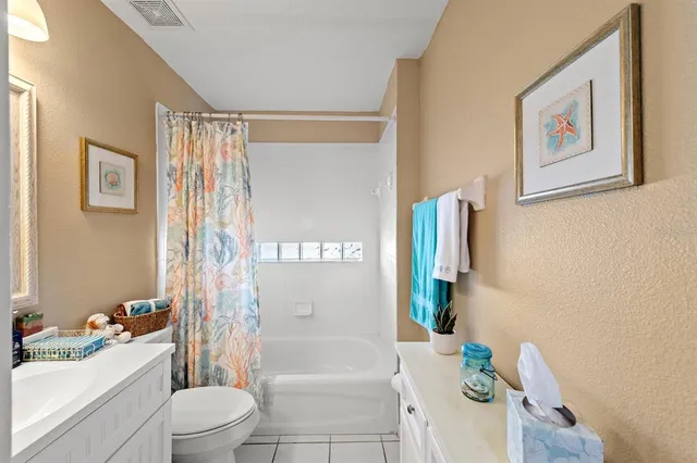 a bathroom with a sink a toilet mirror and shower