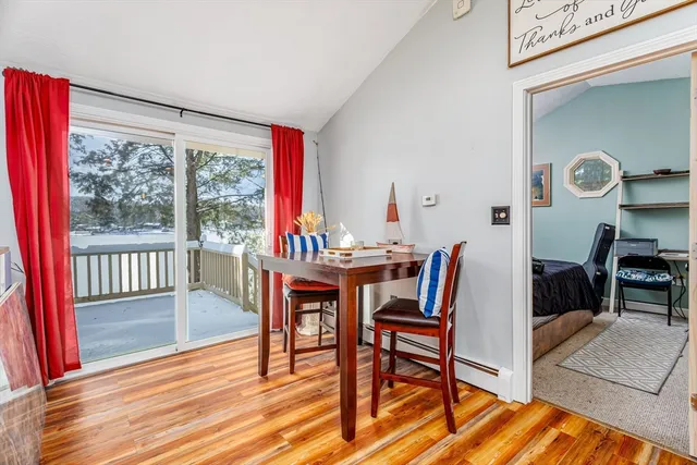 a dining room with furniture and a kitchen view