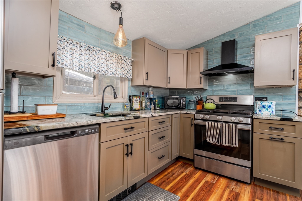 13 Browns Lake Road Ashburnham, MA 01430 - Photo 15 of 33 a kitchen with stainless steel appliances granite countertop a stove a sink and a microwave
