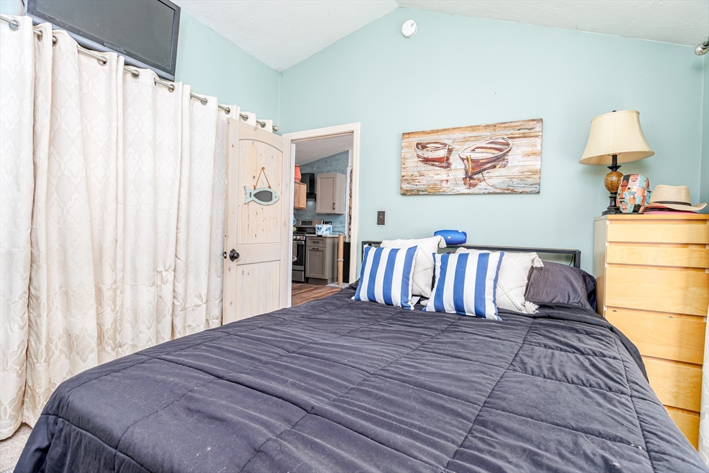 13 Browns Lake Road Ashburnham, MA 01430 - Photo 18 of 33 a bedroom with a large bed and a table