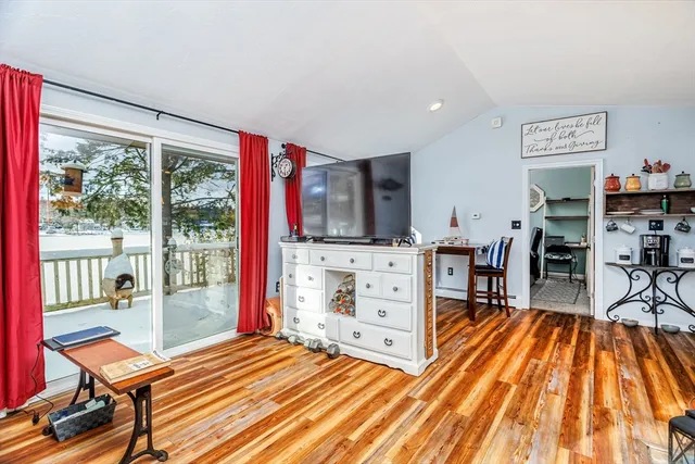 a living room with flat screen tv and a fireplace