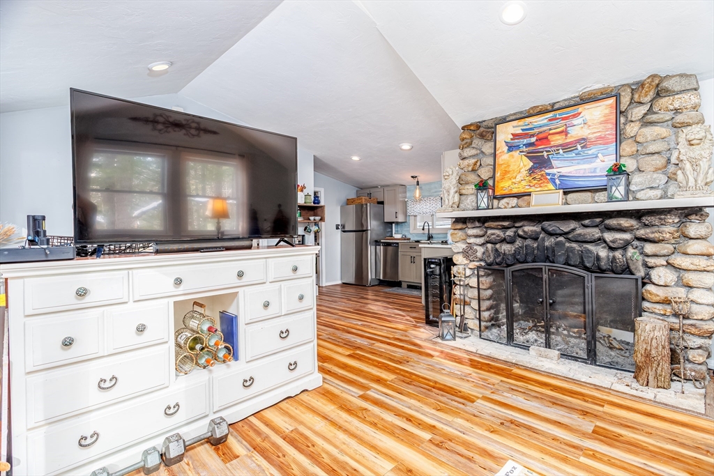 13 Browns Lake Road Ashburnham, MA 01430 - Photo 9 of 33 a living room with flat screen tv and a fireplace