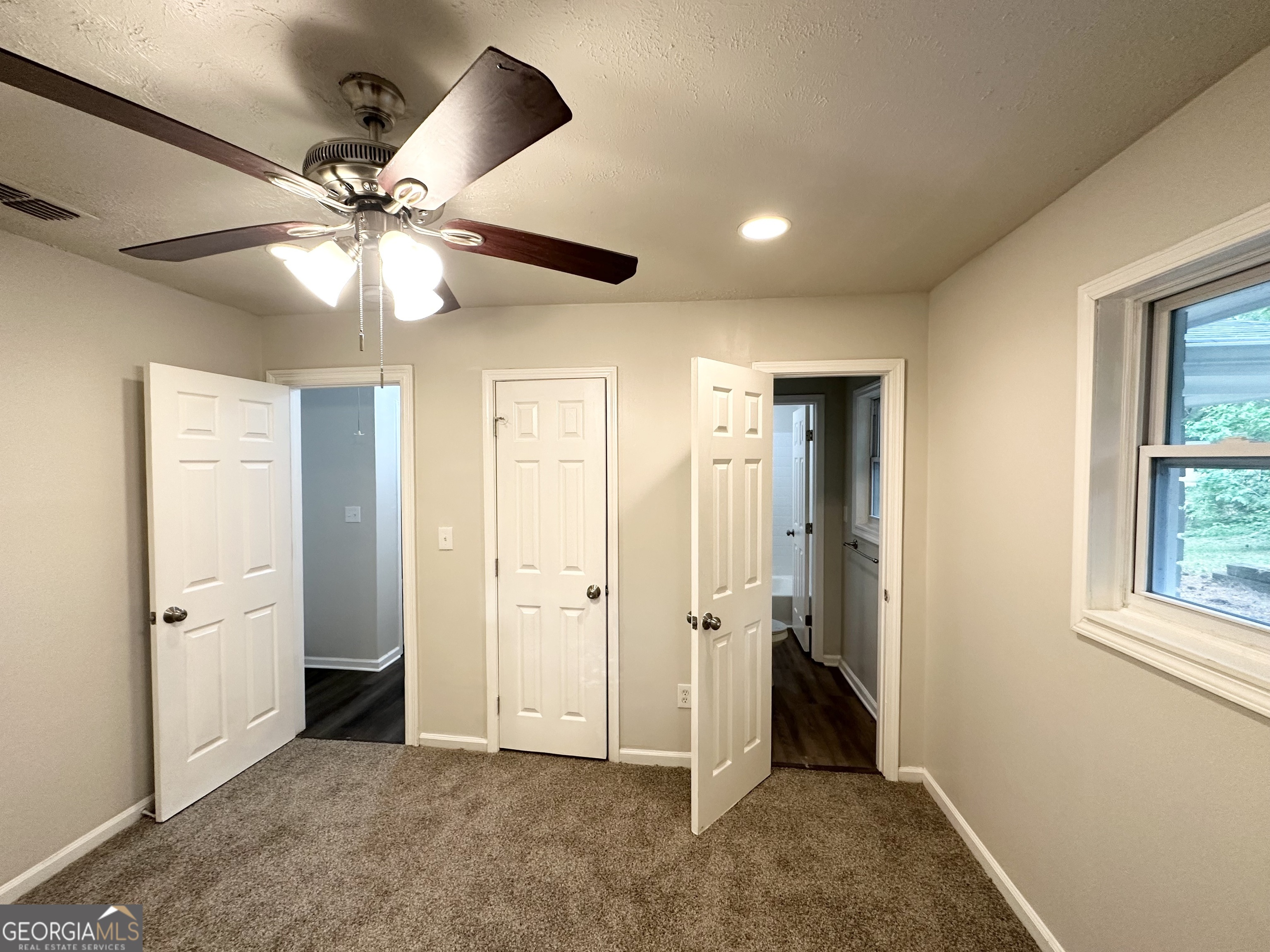 2930 Waters Road Southwest Atlanta, GA 30354 - Photo 11 of 14 an empty room with closet and a ceiling fan