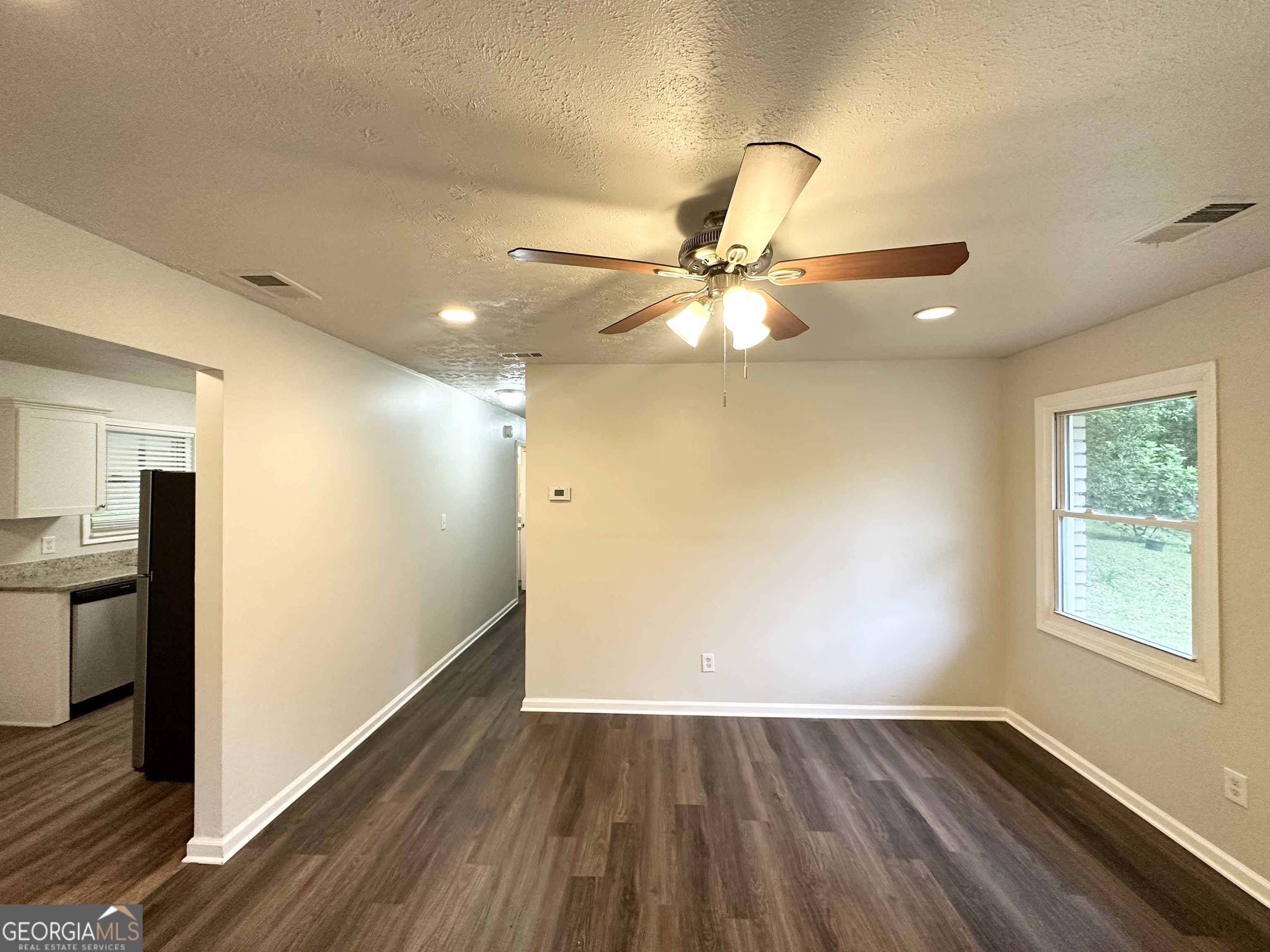 2930 Waters Road Southwest Atlanta, GA 30354 - Photo 2 of 14 an empty room with wooden floor fan and windows