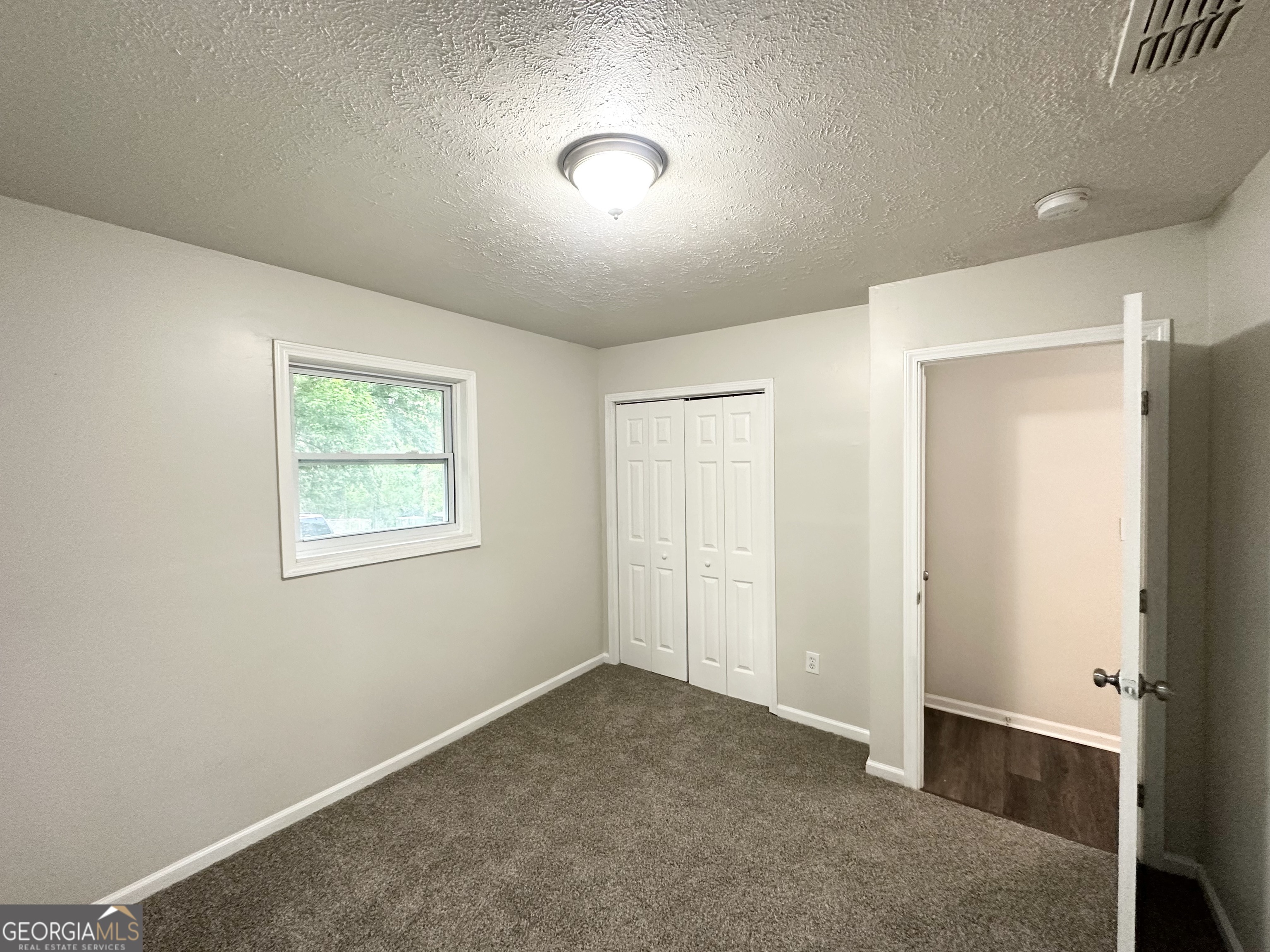 2930 Waters Road Southwest Atlanta, GA 30354 - Photo 9 of 14 an empty room with a empty space and windows