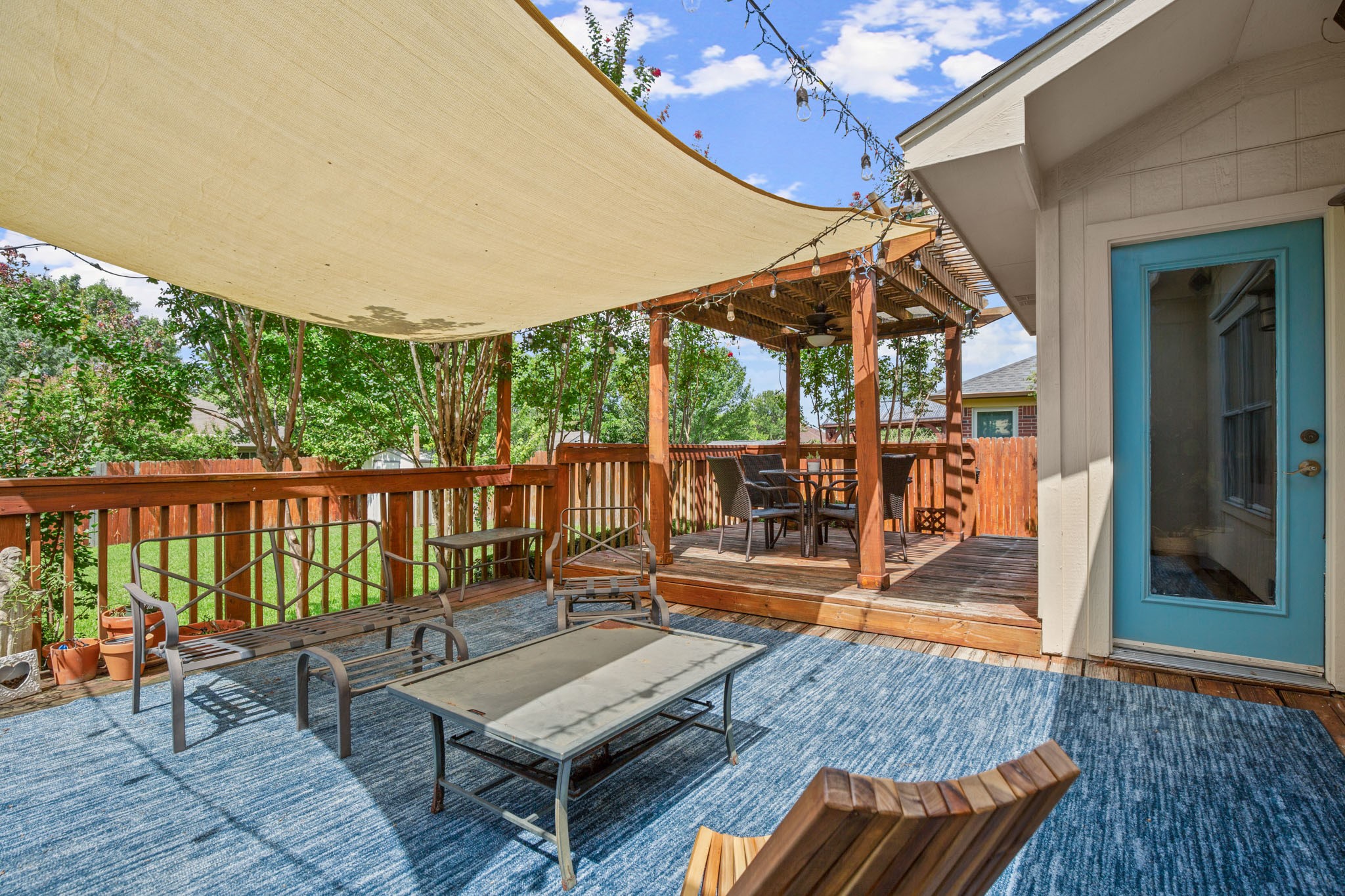 1205 Crossvine Way Pflugerville, TX 78660 - Photo 18 of 20 a balcony with wooden floor table and chairs