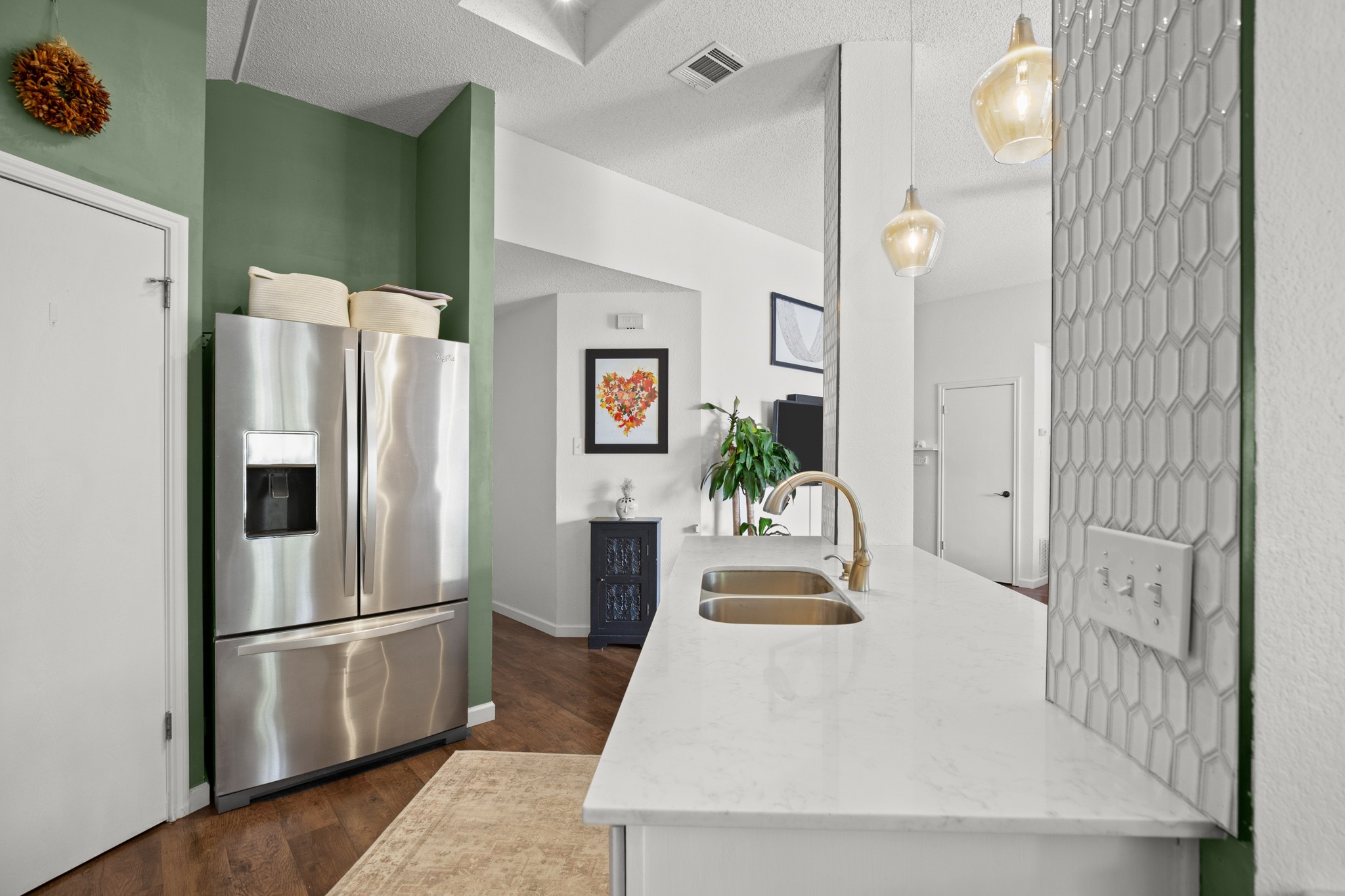 1205 Crossvine Way Pflugerville, TX 78660 - Photo 6 of 20 a kitchen with stainless steel appliances a refrigerator a sink a stove and white cabinets