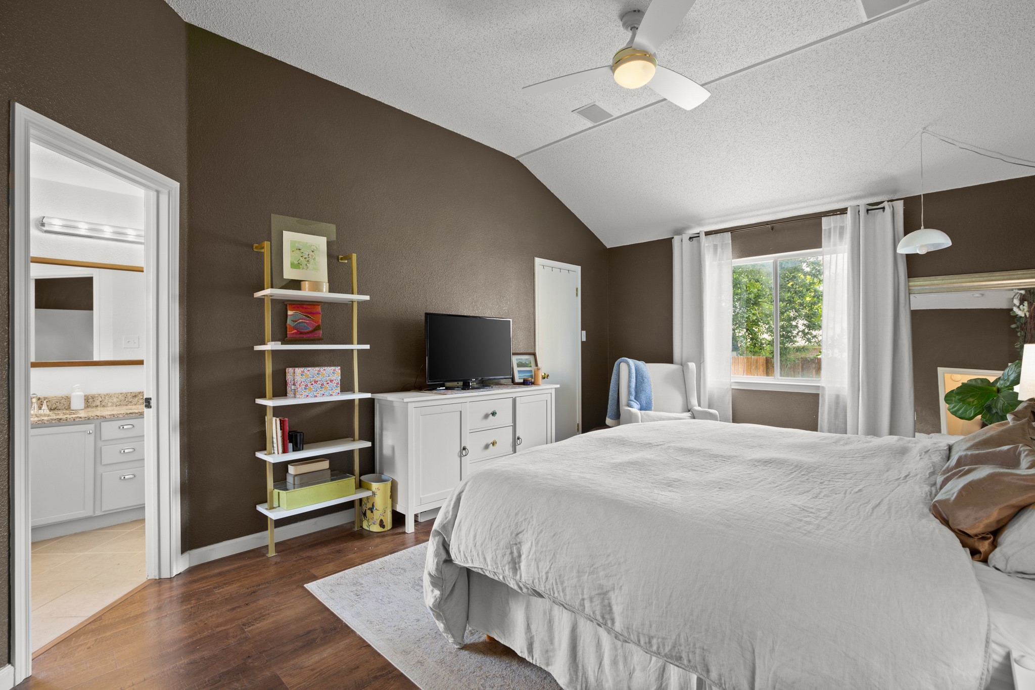 1205 Crossvine Way Pflugerville, TX 78660 - Photo 10 of 20 a bedroom with a bed flat screen tv and a window