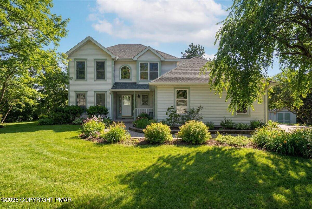 a front view of house with yard and green space
